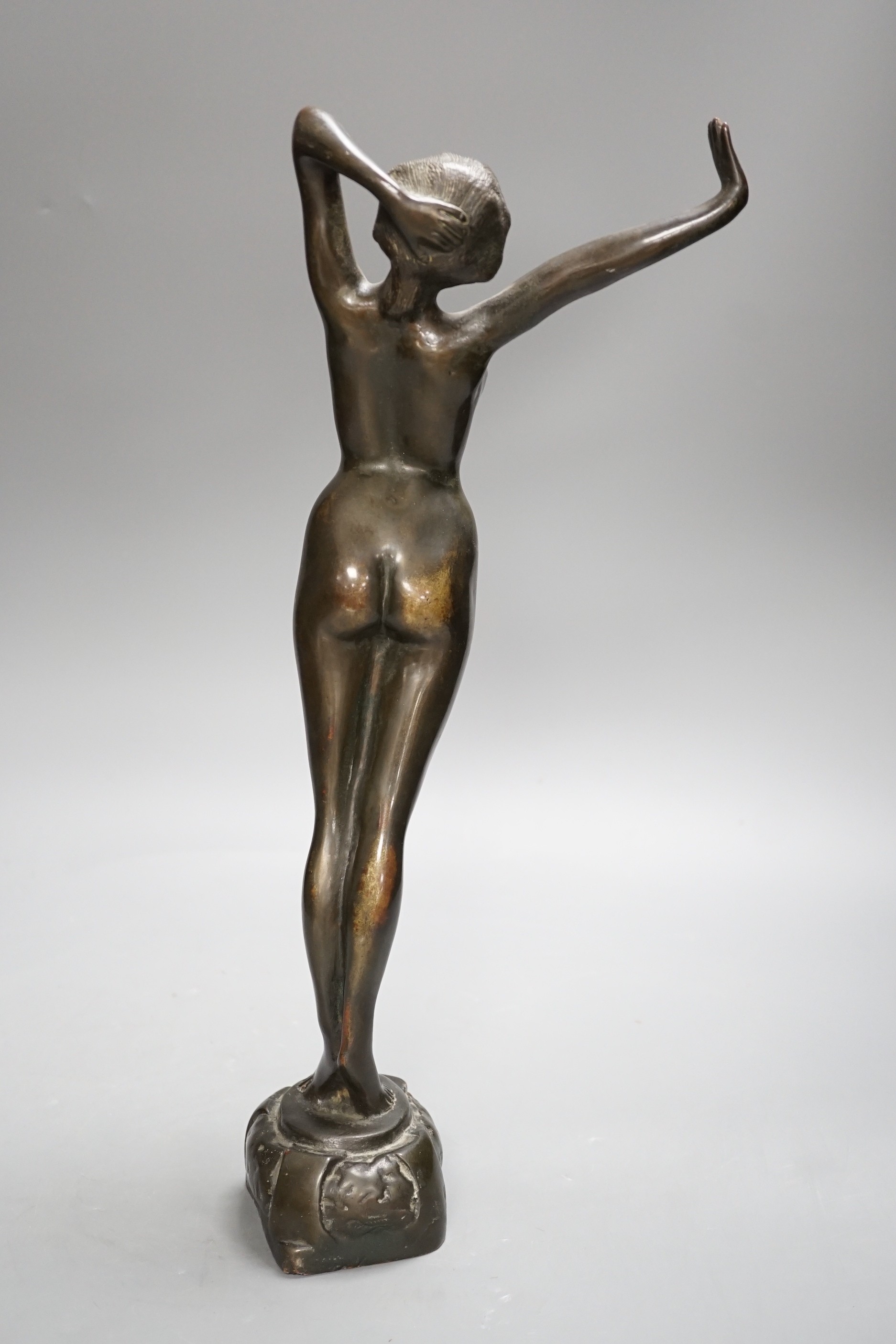 An Art Nouveau style female bronze nude. 39cms high.